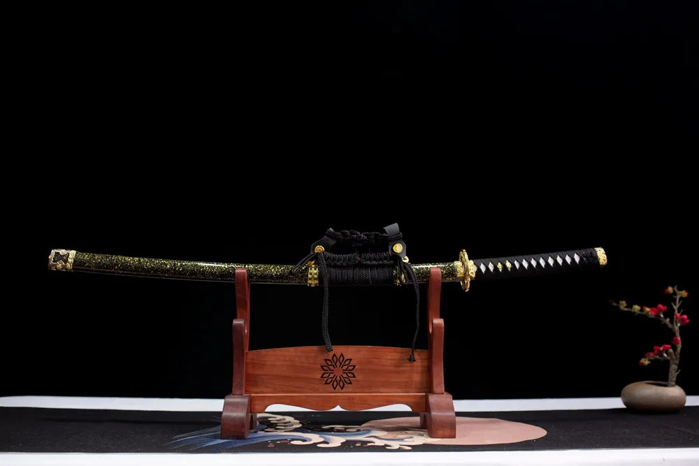 Horizontal laid closed black‑gold speckled Dragon‑Blade‑Tachi scabbard flat table‑top front display