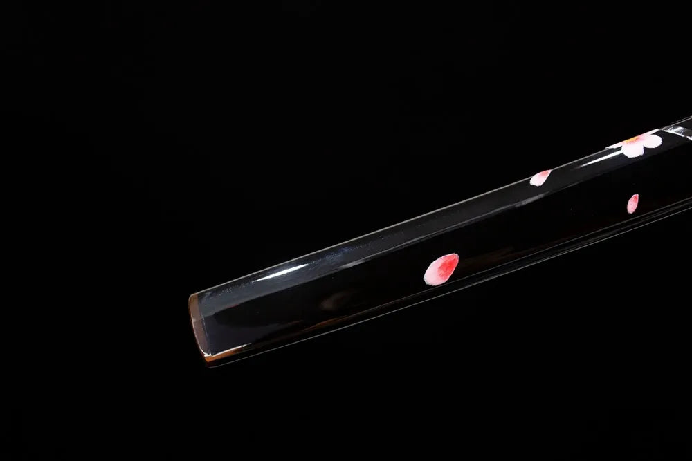 Bottom high‑gloss‑black saya two‑tone aged‑copper kojiri end‑cap close‑up
