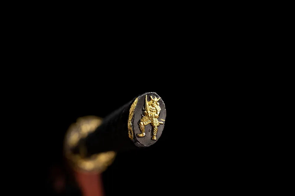 Warrior‑figure sculpted gilded‑alloy pommel‑cap detail shot