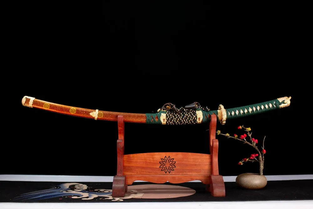Horizontal laid closed orange‑red gold‑maki‑e kamon‑crest Nobunaga‑Orange‑Tachi scabbard flat table‑top front display