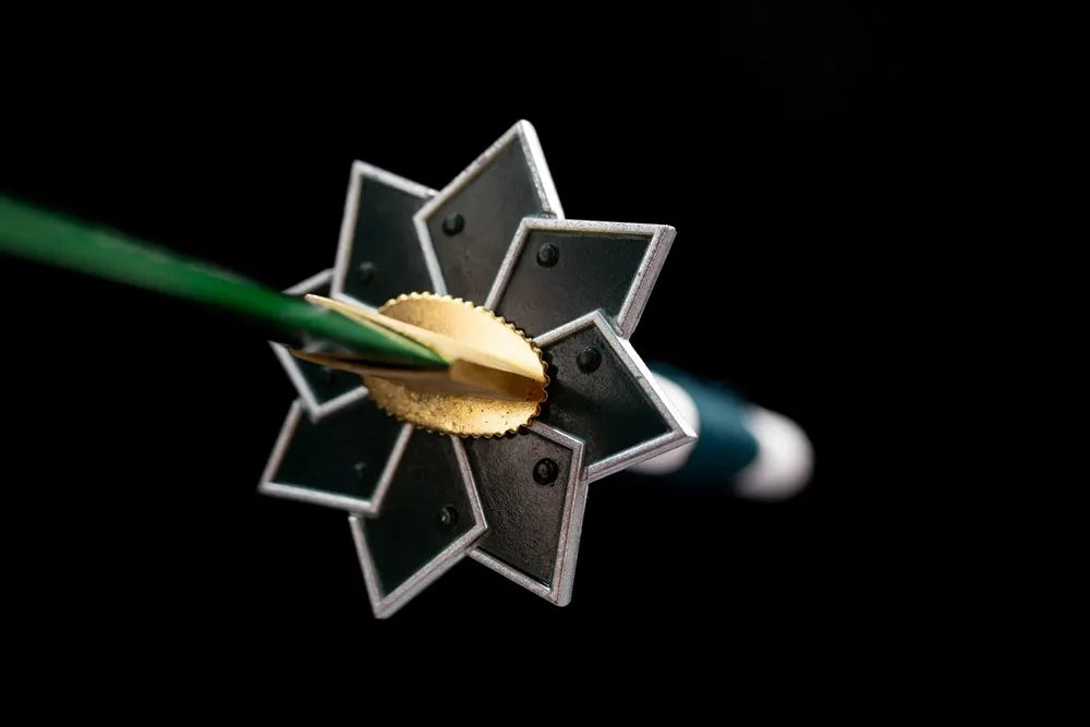 Front eight‑point jagged‑star silver‑green wind‑hashira demon‑slayer hand‑guard close‑up