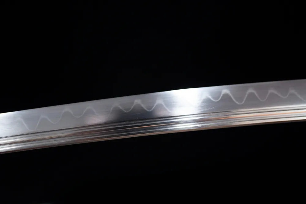 Mid‑section gunome‑midare sun‑moon‑interleaved light‑shadow‑shifting‑pattern hamon steel katana blade surface close‑up shot