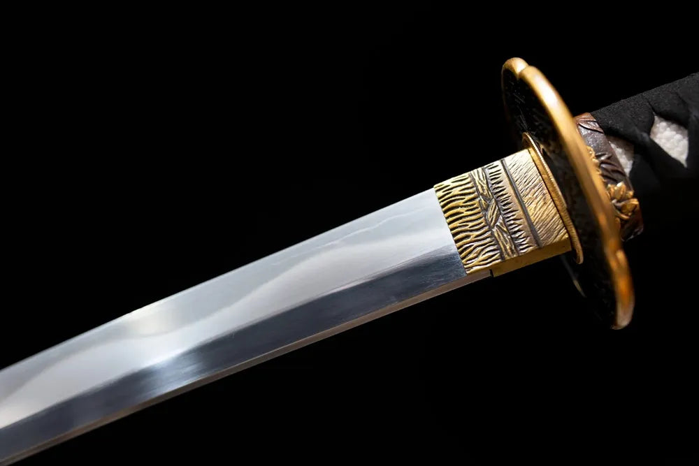 Upper T10 clay‑tempered katana blade brass habaki suguha‑midare moon‑wave shifting hamon temper‑line macro close‑up