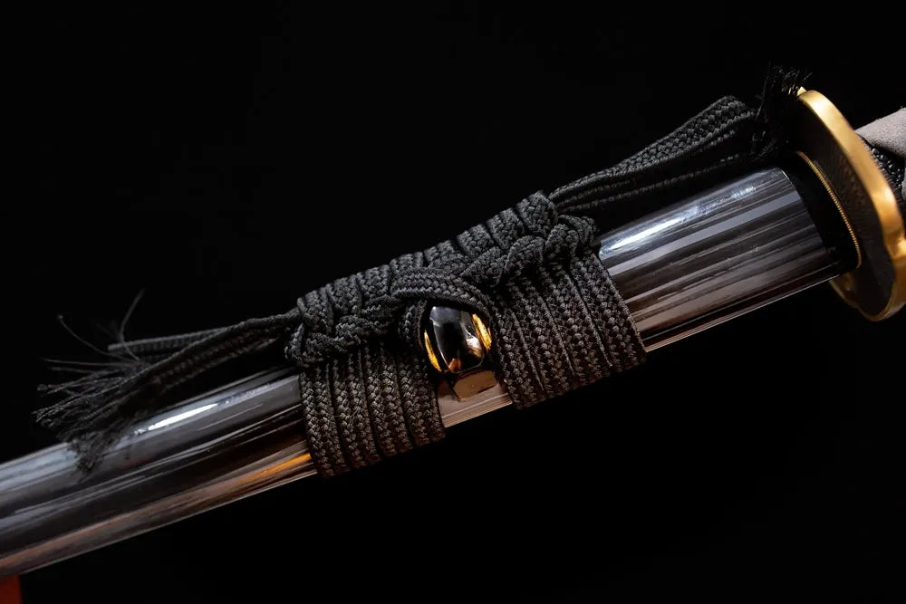 Thick heavy‑black heavy‑braided sageo cord brass fitting macro close‑up