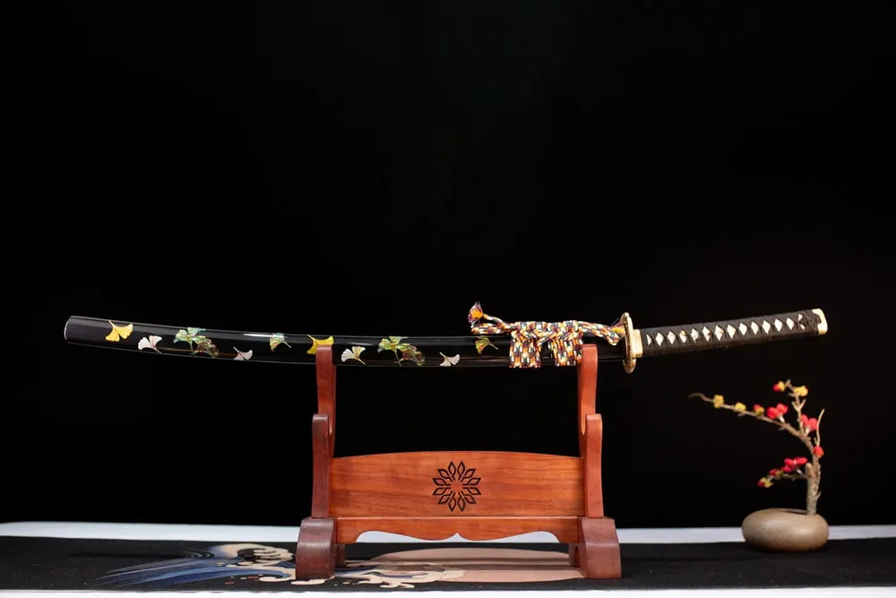 Horizontal laid closed deep‑space‑black gilded meteor‑fall‑trail Meteor‑Shower‑Katana scabbard flat table‑top front display
