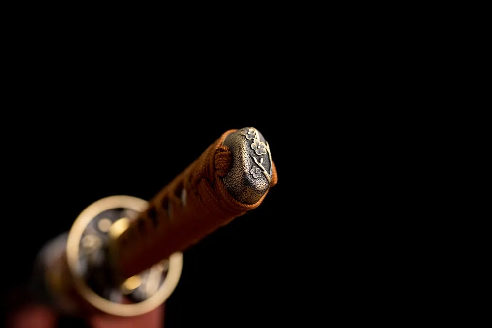 Plum‑blossom relief brass‑alloy pommel‑cap detail shot