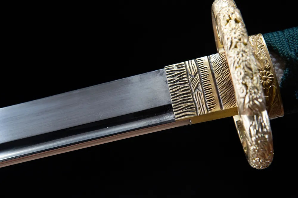 Upper long blade closeup full mirror polished T10 steel near gilded floral brass habaki