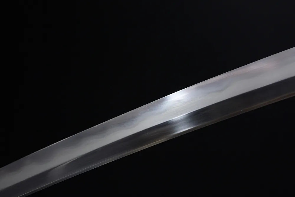 Mid‑section clean suguha straight‑line hamon steel wakizashi blade surface close‑up shot