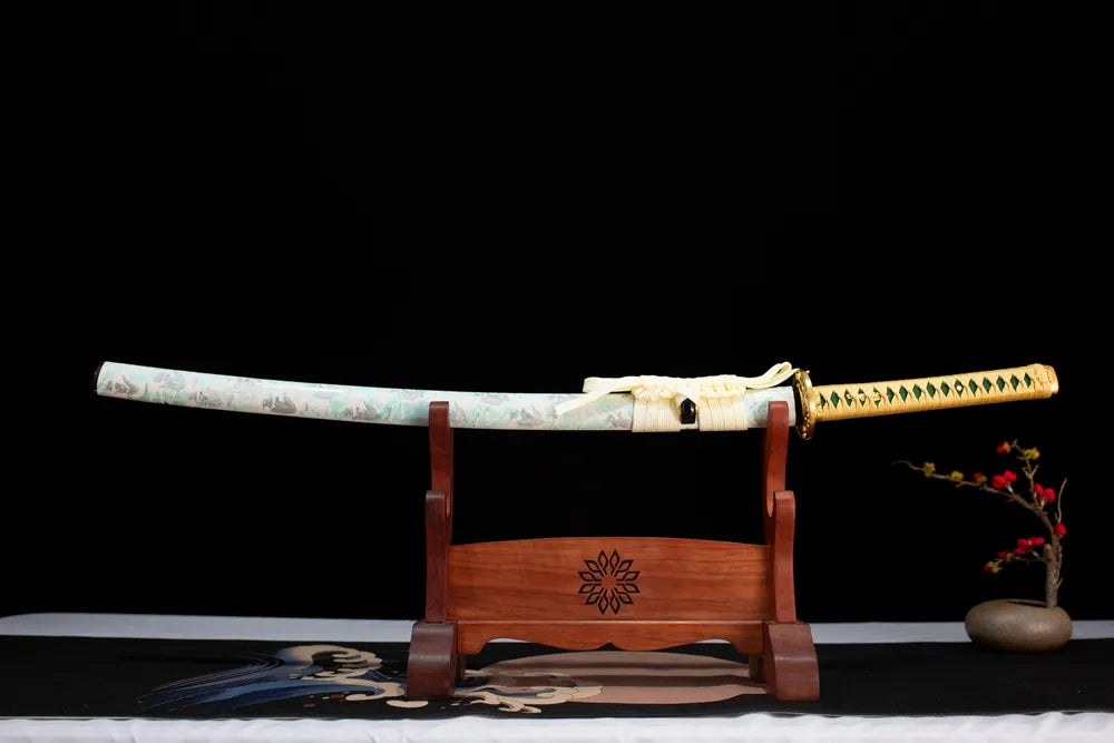 Horizontal laid closed cream‑white pale‑cyan winter‑plum‑blossom Yingxue‑Katana scabbard flat table‑top front display