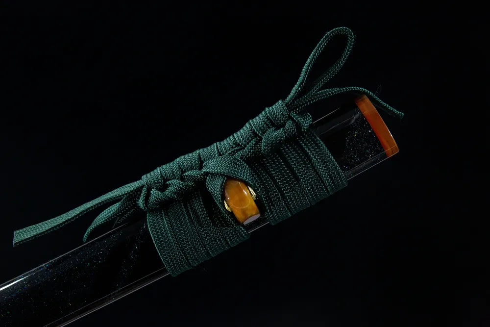 Dark green woven cotton sageo cord tied on amber saya ring