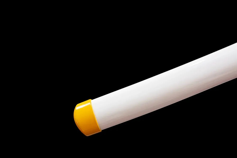 Bottom glossy white saya golden‑trim zinc‑alloy kojiri end‑cap close‑up