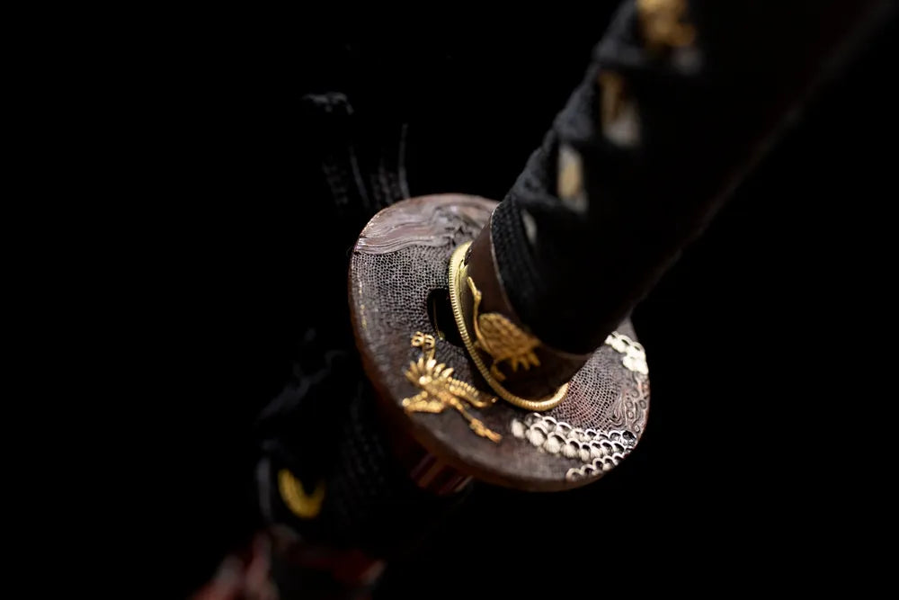Reverse‑side tsurumaru‑crane‑crest carving antique‑brass tsuba surface texture close‑up