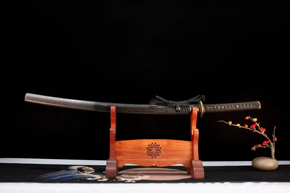 Horizontal laid closed charcoal‑black pearl‑crack‑texture Hell‑Katana scabbard flat table‑top front display