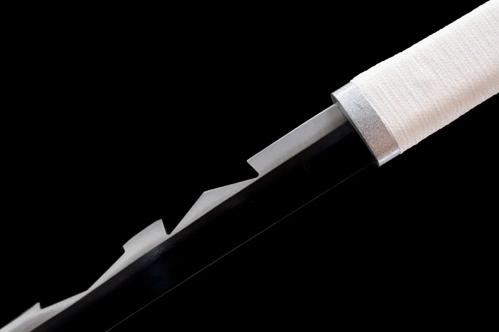 Upper serrated 1060 steel blade and rugged habaki macro close‑up