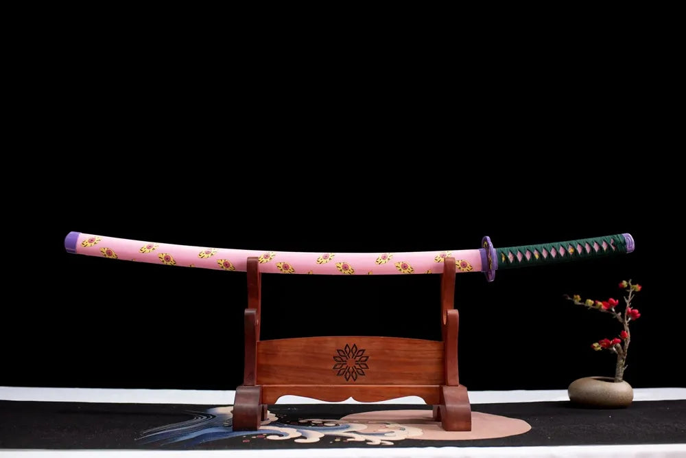 Horizontal laid closed pink demon‑eye‑print Kokushibo scabbard flat table‑top front display