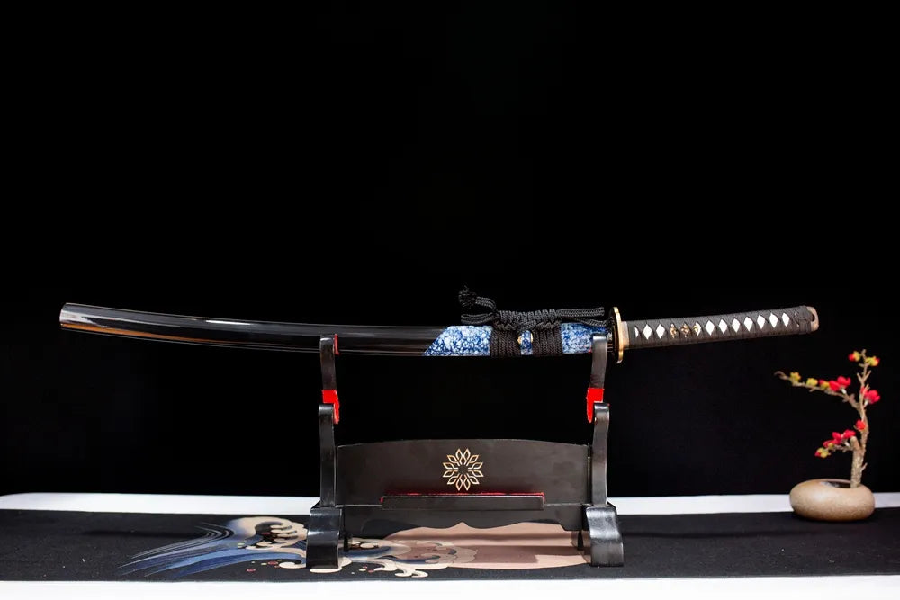 Horizontal laid closed deep‑void‑black star‑orbit‑comet‑tail Comet‑Katana scabbard flat table‑top front display