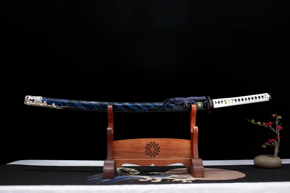 Horizontal laid closed deep‑blue flow‑grain long katana scabbard flat table‑top front display