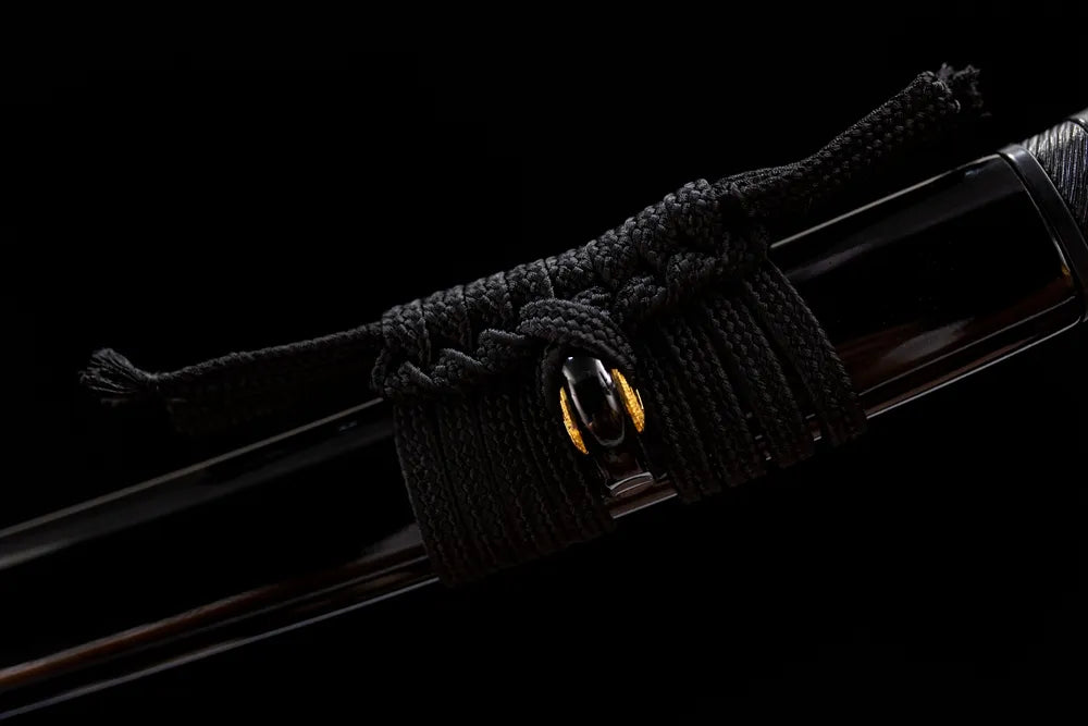 Thick black braided mini sage cord golden fitting close-up