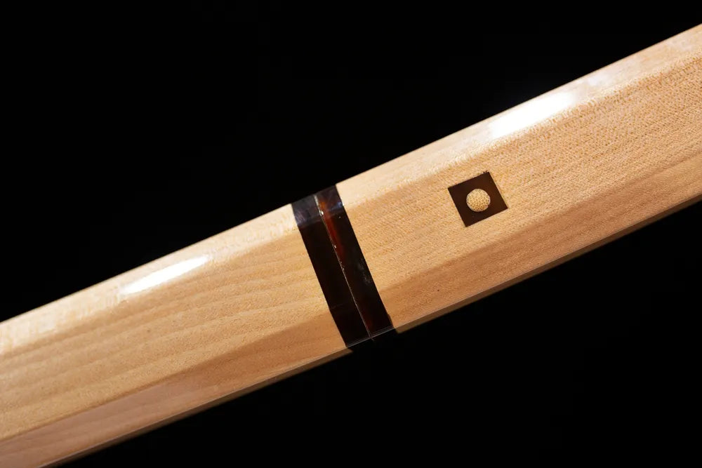 Plain‑unadorned natural‑wood fuchi grip‑ring macro close‑up