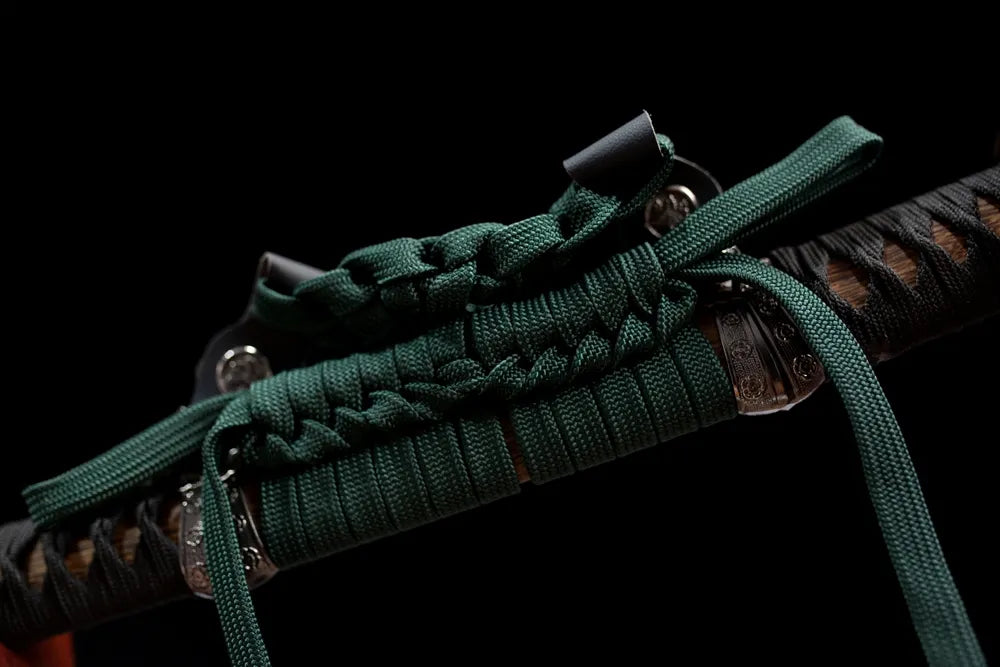 Thick dark‑olive‑green braided tachi‑no‑sageo cord brass‑alloy fitting macro close‑up