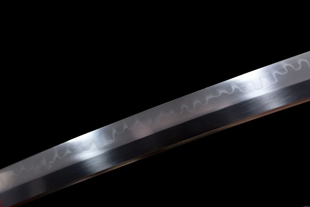 Mid‑section composite mixed‑pattern hamon steel katana blade surface close‑up shot