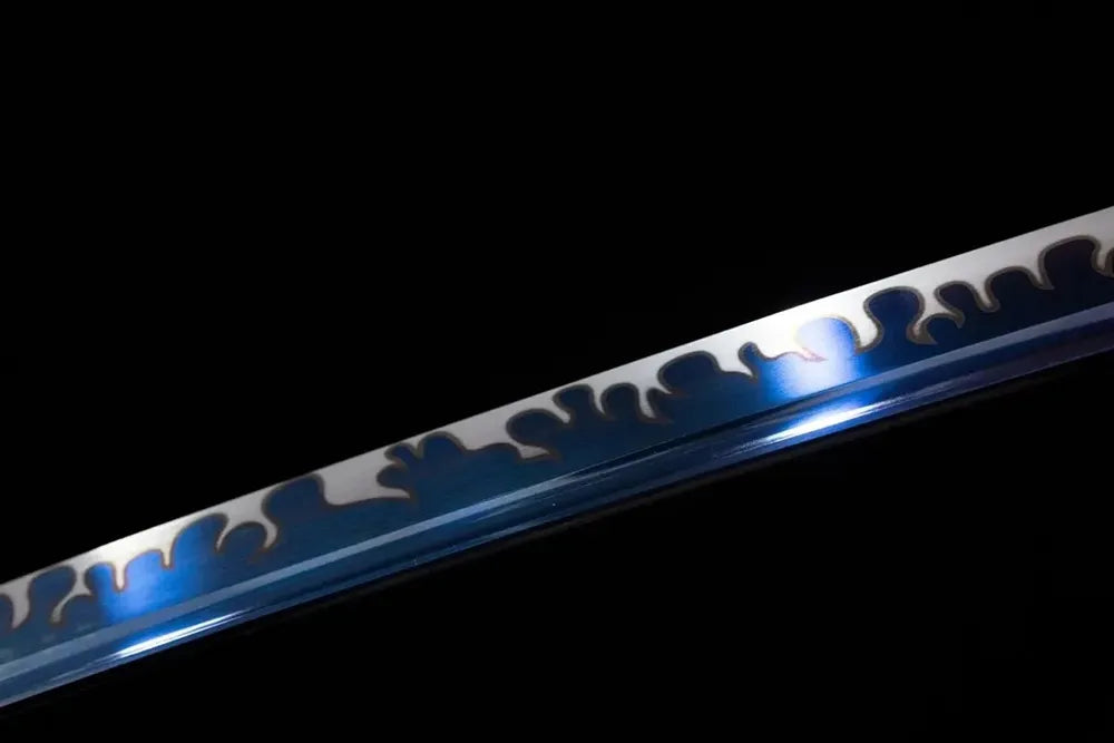 Mid‑section blue‑tinted‑etched wavy‑ornamental‑pattern steel katana blade surface close‑up shot