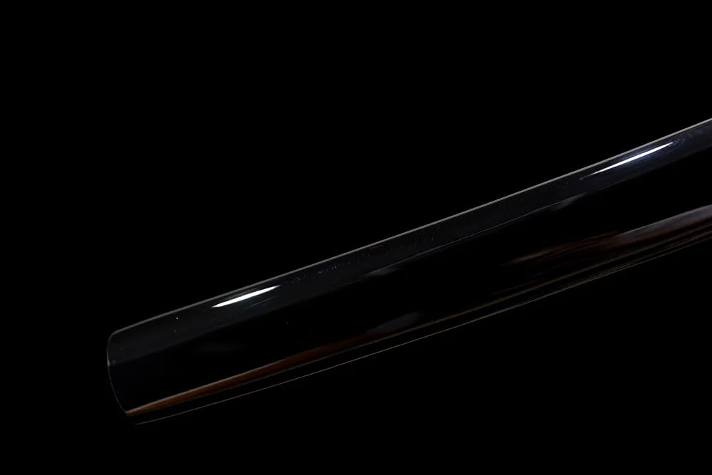 Bottom matte‑black scarlet‑spider saya aged‑alloy kojiri end‑cap close‑up