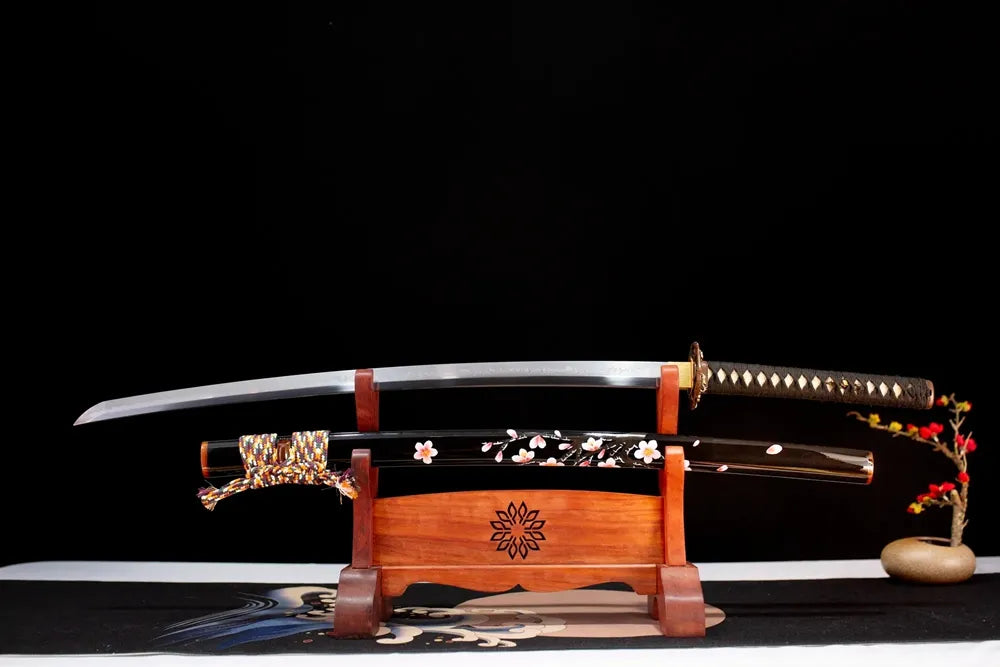 Flat fully‑drawn T10 clay‑tempered splash‑pattern‑hamon Sakura‑Katana blade wooden rack front shot