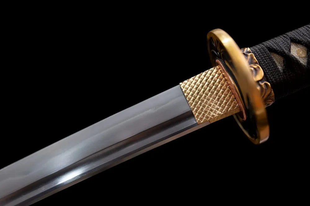 Upper T10 clay‑tempered steel blade brass habaki sakura‑blossom etching macro close‑up