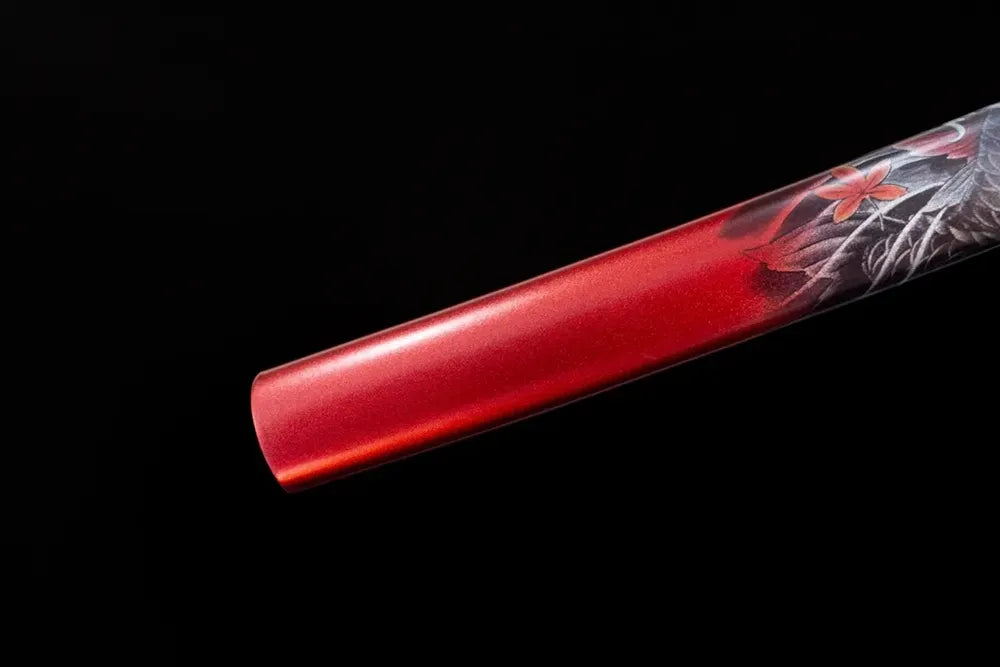 Bottom fiery‑red saya brass‑gilded kojiri end‑cap close‑up