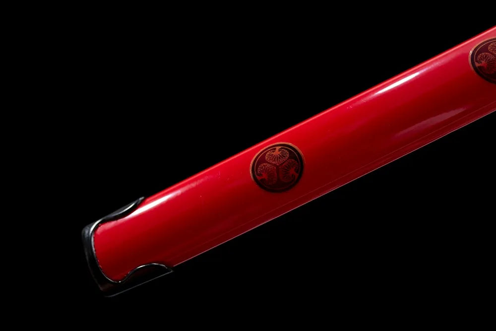 Bottom bright‑red saya dark‑alloy kojiri end‑cap close‑up