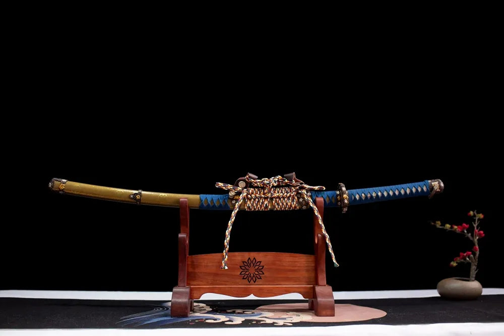 Horizontal laid closed vintage‑brown gilded‑mon Tachi‑Fukushima‑Masanori scabbard flat table‑top front display