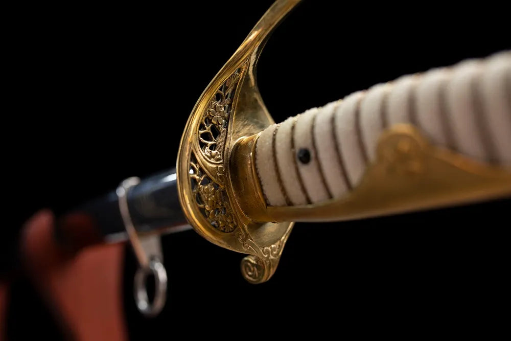 Reverse side open‑work carving texture of brass D‑guard close‑up