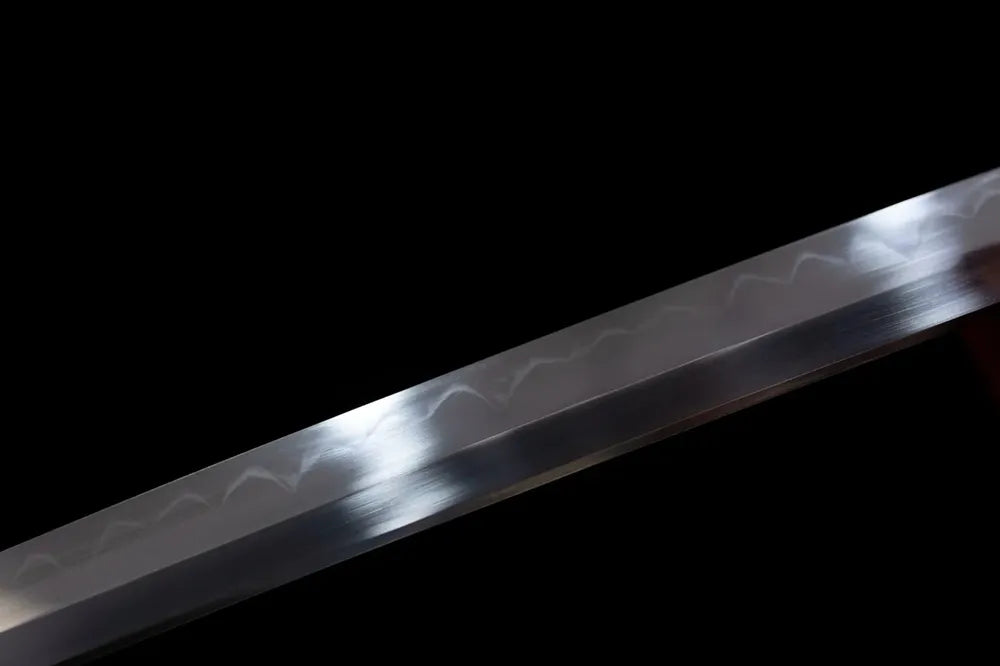 Mid‑section natural wave‑pattern hamon steel blade surface texture close‑up shot