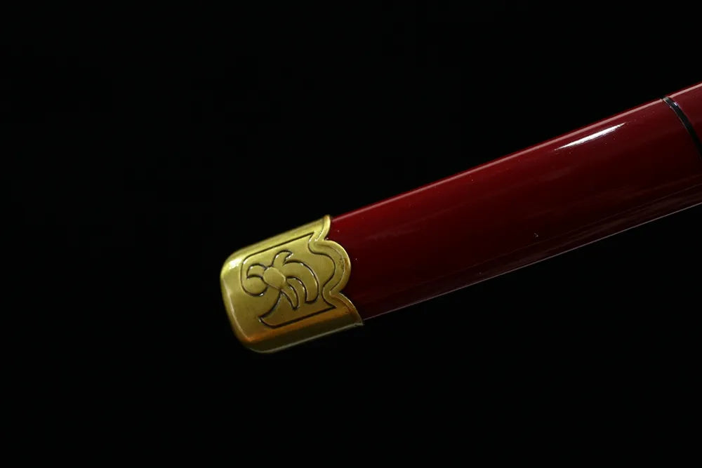 Bottom bright‑red lacquer saya alloy end‑cap close‑up