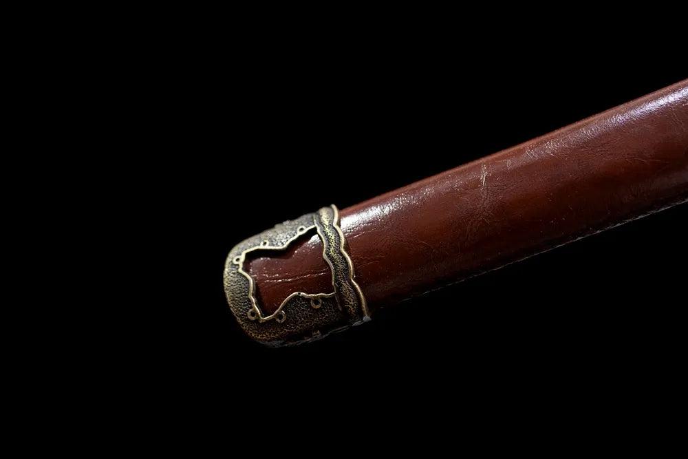 Bottom brown faux‑leather saya vintage‑brass kojiri end‑cap close‑up