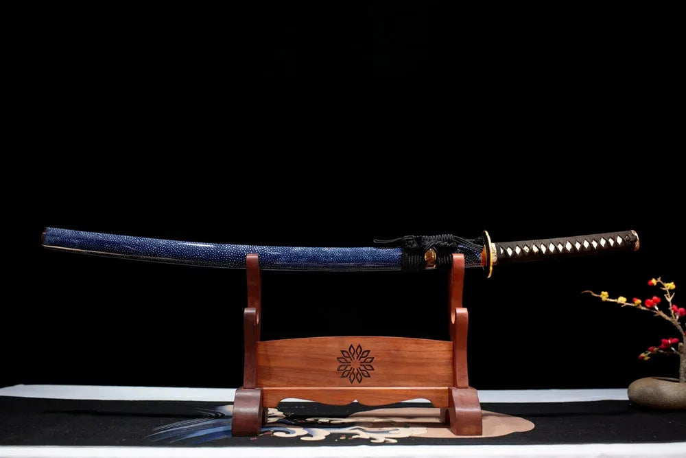 Horizontal laid closed ice‑blue moon‑pearl maki‑e Blue‑Moon‑Katana scabbard flat table‑top front display