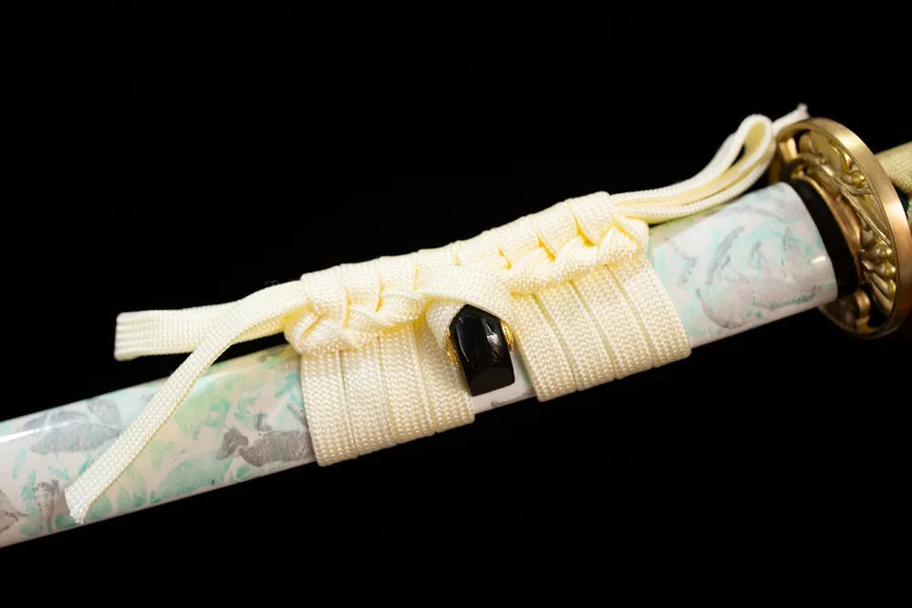 Thick cream‑white mixed‑braided sageo cord gilded‑alloy fitting macro close‑up