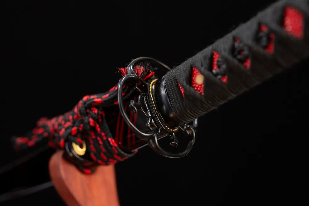 Reverse‑side floral‑scroll carving black‑iron tsuba surface texture close‑up