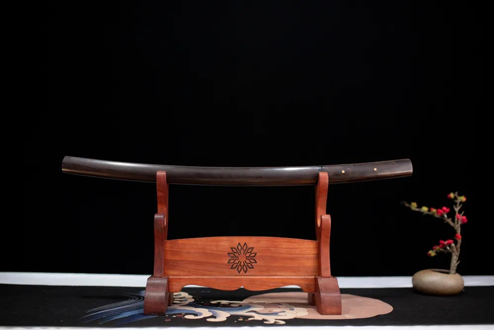 Horizontal laid closed high‑gloss solid‑black precious‑hardwood Night‑Elf‑Wakizashi scabbard flat table‑top front display