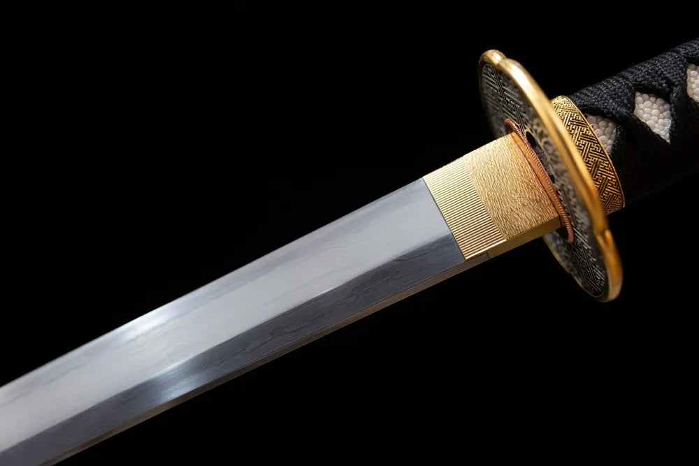 Upper sanmai‑forged T10 clay‑tempered katana blade brass habaki clean suguha straight hamon temper‑line macro close‑up