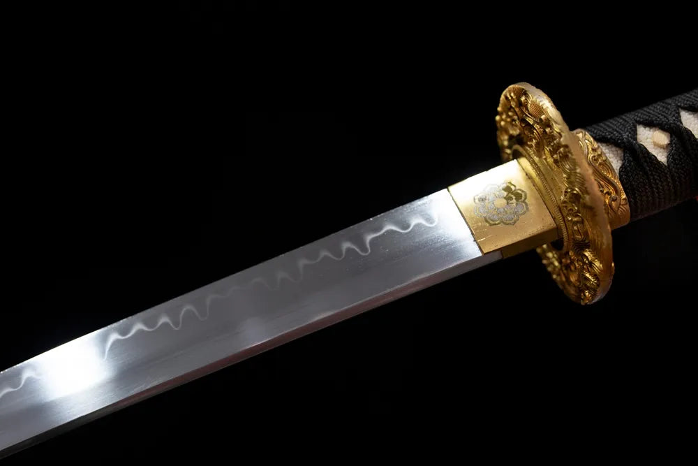 Upper T10 clay‑tempered katana blade brass habaki midare‑gunome meteor‑tail‑flame‑ripping hamon temper‑line macro close‑up