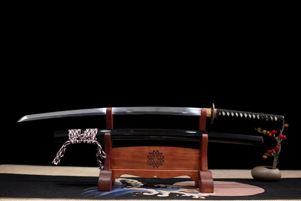 Flat fully drawn T10 clay‑tempered natural hamon Black‑Whirlwind‑Katana blade wooden rack front shot