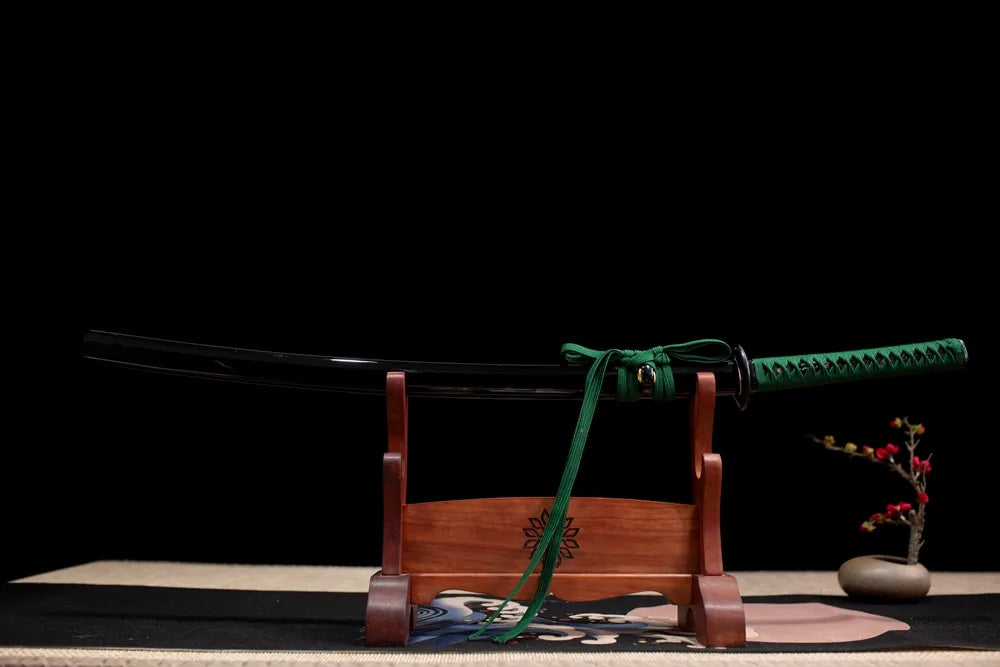 Horizontal laid closed dark‑green gradient python‑textured Green‑Python‑Katana scabbard flat table‑top front display
