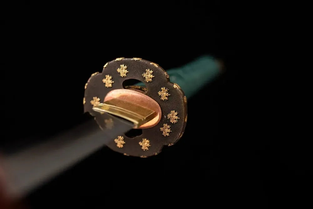 Front open‑work maple‑leaf‑relief gilded‑bronze katana hand‑guard close‑up