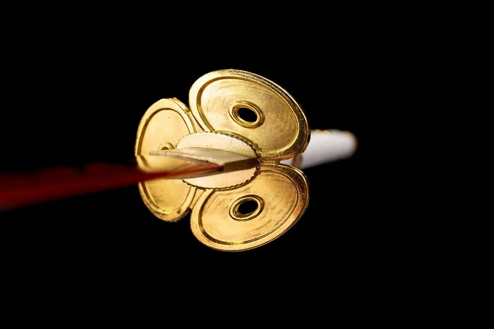 Front distinctive hollow trefoil‑flower gold‑plated Wano‑theme hand‑guard close‑up