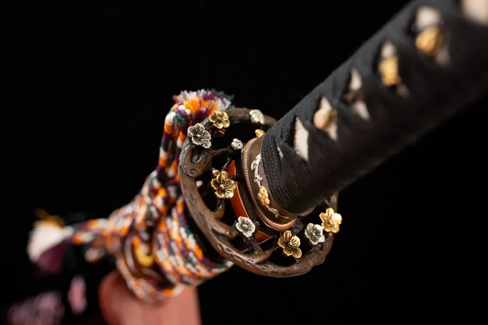 Reverse‑side cherry‑branch‑scroll carving two‑tone aged‑copper tsuba surface texture close‑up