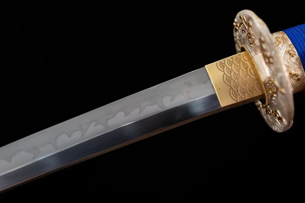 Upper T10 clay‑tempered katana blade brass habaki midare‑sanbonsugi sea‑dragon‑surge‑undulating hamon temper‑line macro close‑up