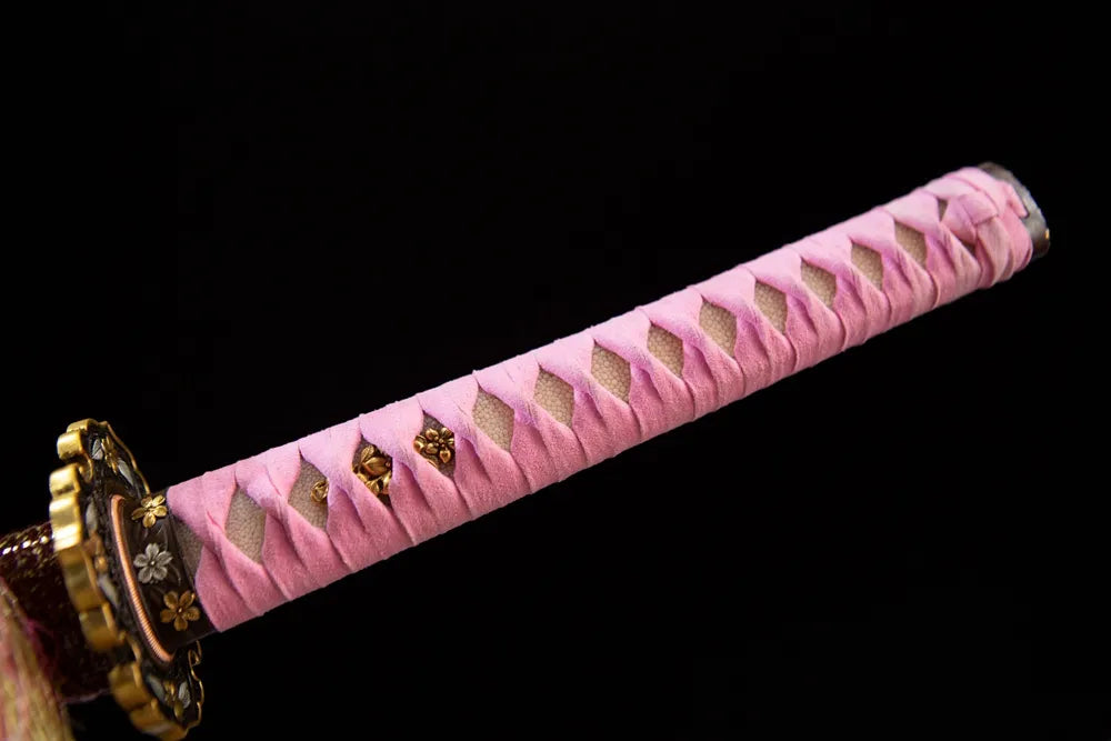 Full pink cotton wrapped tsuka with gold flower menuki front shot