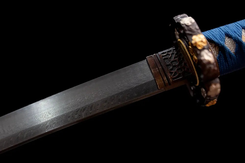 Upper multi‑layer damascus oil‑quenched tachi blade copper habaki layered metal grain macro close‑up